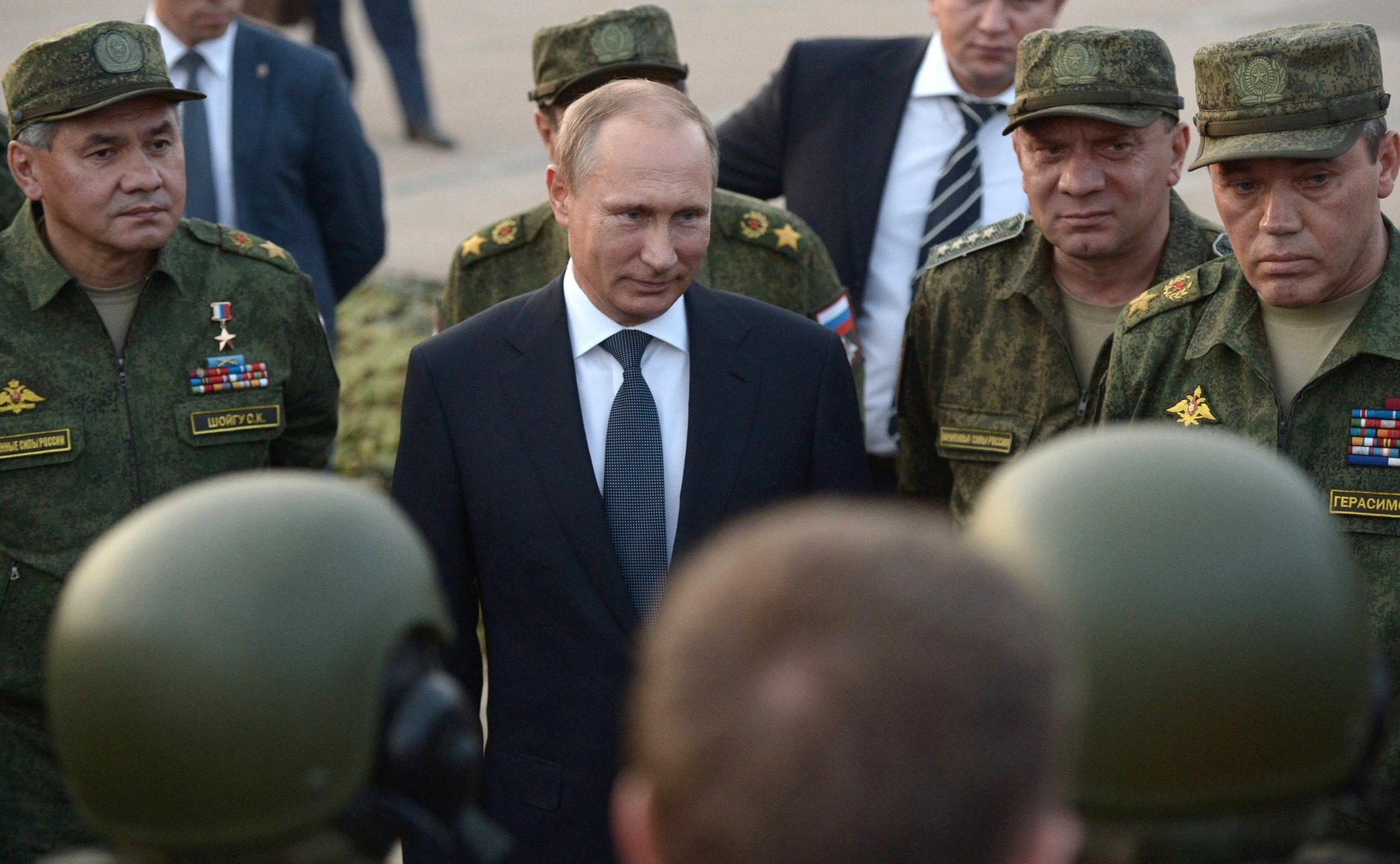 Russian leader Vladimir Putin faces members of the military